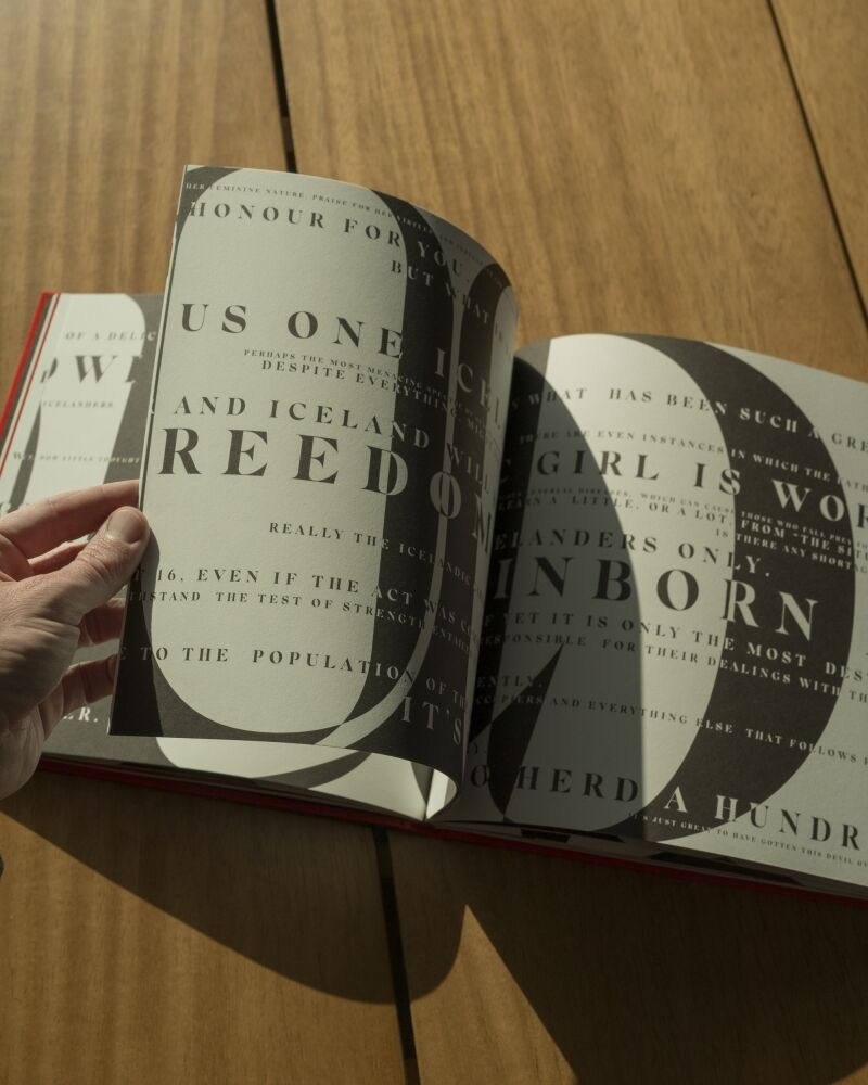 Woman flips page of book Quite the Situation by Inki.