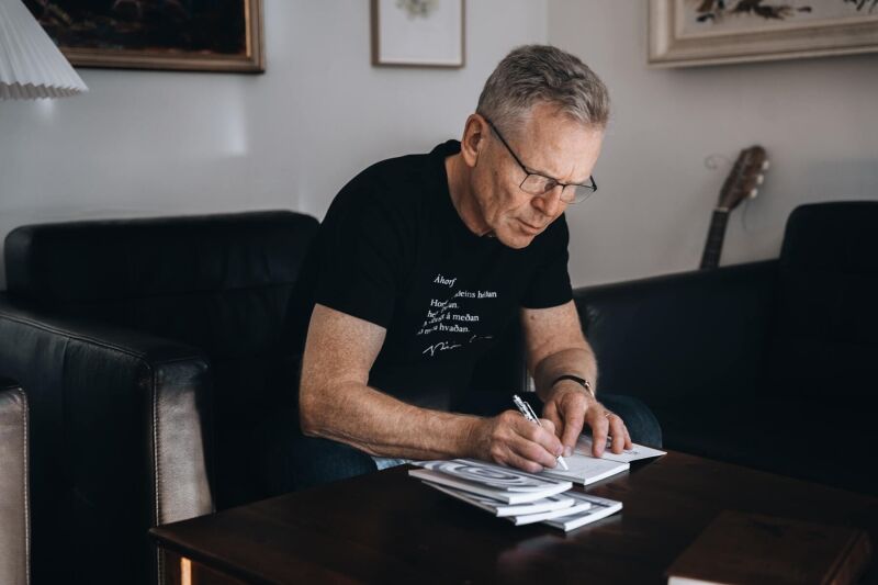 Þórarinn Eldjárn, an acclaimed Icelandic author, is seen signing a book, promoting the hotel’s special "Book Lover" offer. The scene captures the warm interaction between the author and the guest, surrounded by a cozy atmosphere that invites literary enthusiasts to explore Icelandic literature during their stay.
