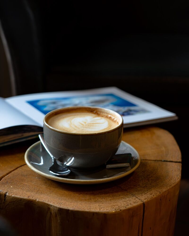 A cup of coffee sits on a wooden table at Hotel Rangá.