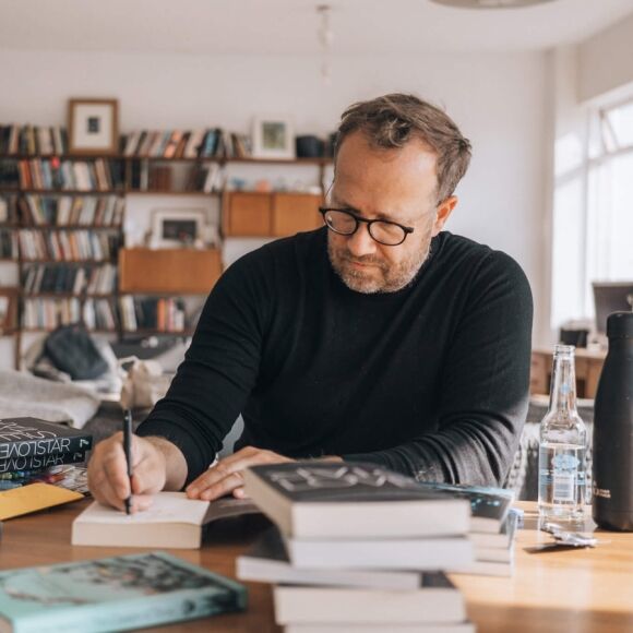 The author Andri Snær Magnason signs his book Love Star.