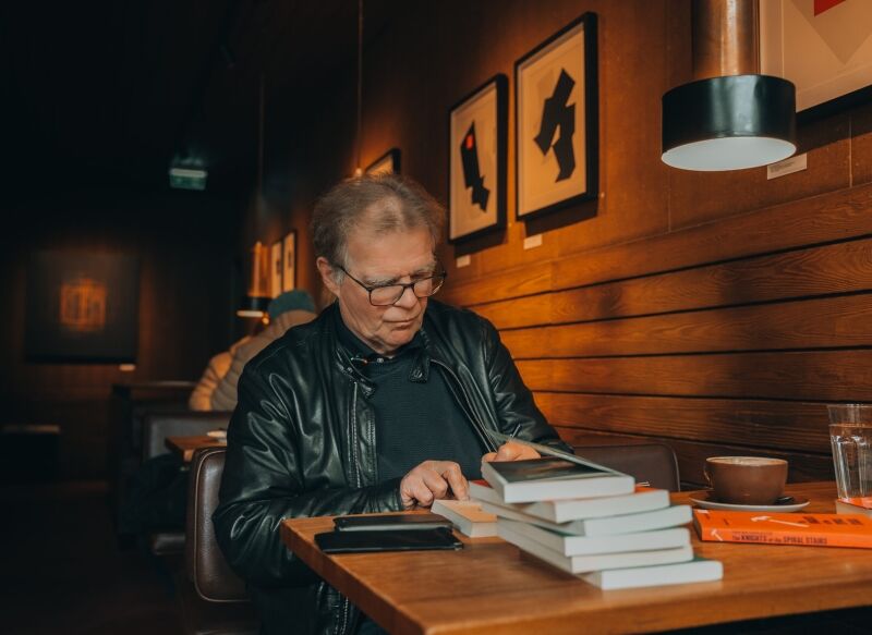 Einar Már Guðmundsson, an Icelandic novelist, signs books.